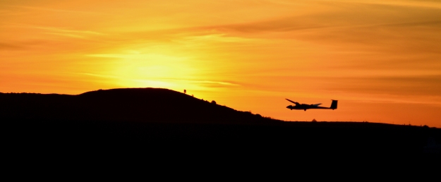 Landing glider in sunset